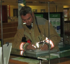 Burlington firefighter does his paper work for what turned out to be a non event when the fire alarms went off at city hall.