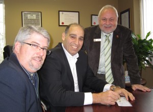 When it took a small amount to get the United Way over the top Sakran took out his cheque book while Timothy Brown and Len Lifchus, both of the United Way, looked on approvingly.