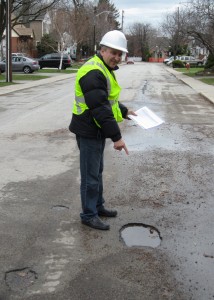 Italo DiPietrol points out a pot hole on Holtby Street, a 50 year old road that is due for repair this summer.  Burlington has not set aside enough in the way of funding to get all the road work done – but Holtby and Crosbie will get total rebuilds this year.