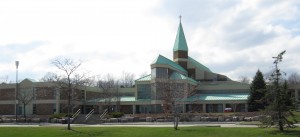 A mammoth structure that dominates the skyline and has three levels of parking with a large sanctuary that includes two television cameras that broadcast the service.  Costs of repair a roof and accumulated debt plus operating expenses resulted in the consolidation of two congregations into the one building.