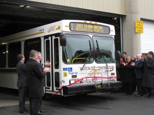 New bus cuts through a ribbon at the opening of the new Transit Operations Centre.  Lot of city hall talent on hand to cut a ribbon.  How much did it cost to have them all there to get their picture taken?  Did they take the bus or did they drive individual cars?