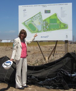 Cindy Mercanti stands before the bill board that shows what is about to be built on the site north of Dundas and West of Walkers Line.  Major change for that part of Burlington.