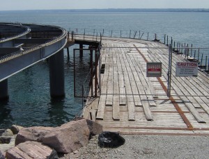 The trestle has been almost as much of a headache as the Pier.  It was essential to have a trestle in place to do the construction work. Whoever gets the contract to complete the construction of the Pier is going to need a trestle.  The one in place now belongs to Bermingham Construction who was a subcontractor to  Harm Schilthuis and Sons, who walked off the job.  The trestle owner wants his trestle back or wants to be paid.  The city has said – take it out by the end of September.  That should solve that problem – right?  It’s never that simple with our Pier.  