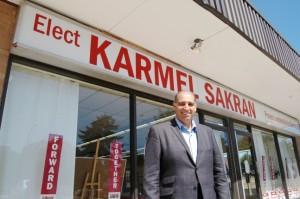 Karmel Sakran in front of his campaign office, which is located north of the QEW – a change from the usual campaign office locations on Fairview.  Sakran says the decision to be north of the QEW was strategic.