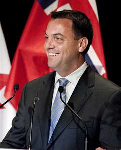 Tim Hudak - with flag Liberals accusing Tim Hudak of breaking a promise. He says he’s just “thinking” about a change.