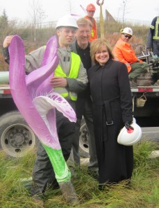 The Phhoto Op - Artist Alex Pentek on the left, displays a portion of the Orchid to Councillors Sharman and Lancaster