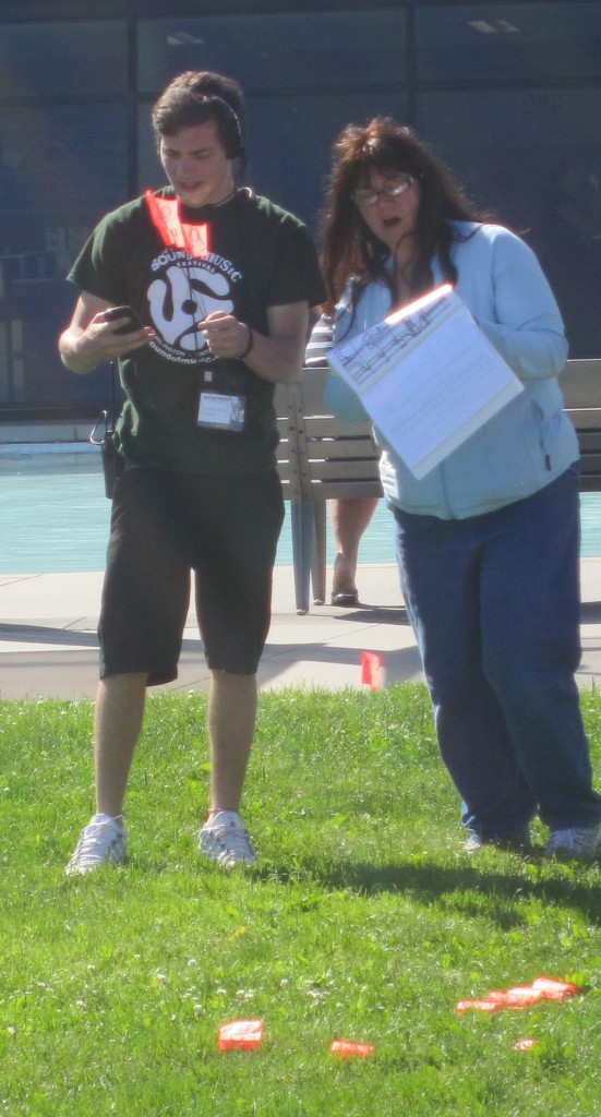 Hundreds of volunteers make the Sound of Music Festival work - two of them mark the location for a vendor.