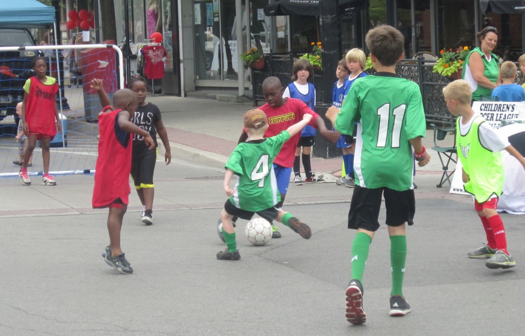 The pavement didn't seem to be a problem. Get a dozen kids and a soccer ball plus two nets and you've got a game. It was pleasant to watch - some benches would have kept people around longer.