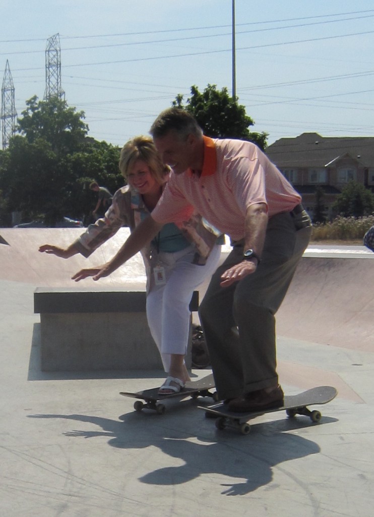 Ward Councillor Blair Lancaster and Mayor Rick Goldring put their political repitations on the line and stand on skate baords. Is there one foot on the ground there? 