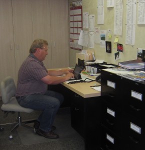 S Henry at his desk