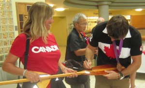 Susan Fraser brought her canoe paddle to the civic reception for the Olympians hoping that MArk Oldershaw would autograph it for her.  He willingly signed the paddle which will probably never go into the water again.