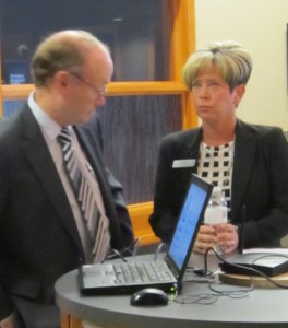 Burlington Community Foundation cahir Tim Dobbie confers with Executive Director Coleen Mulholland before deliver a research report with some stunning data.