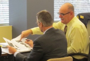 Transit Director Mike Spicer, in the yellow shirt, shows Mayor Goldring what he wants in the way of new buses. The MAyor and council obliged and gave Spicer the go ahead to buy smaller buses.