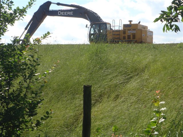 Heavy construction equipment parked on a 30 foot + hill 50 yards from the kitchen window of the Sheldon property on Appleby Line next door to the Air Park landfill operation. Many thought the overnight parking of the equipment overnight was intimidating