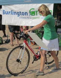 BurlingtonGreen Executive Director Amy Schnur with the bike that was donated by the Mountain Equipment Co-op as art of the drive to increase votes for the Call of the Wild $100,000 contest.
