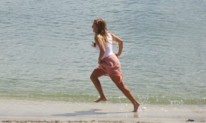 Woman running on mini beach