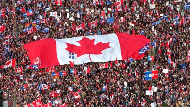 A massive Canadian flag was passed hand over hand amongst a huge crowd in Montreal days before the citizens of Quebec voted in their referendum to remain a part of Canada.