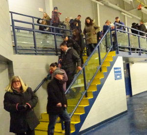 Budget public parent on stairs at ice rink