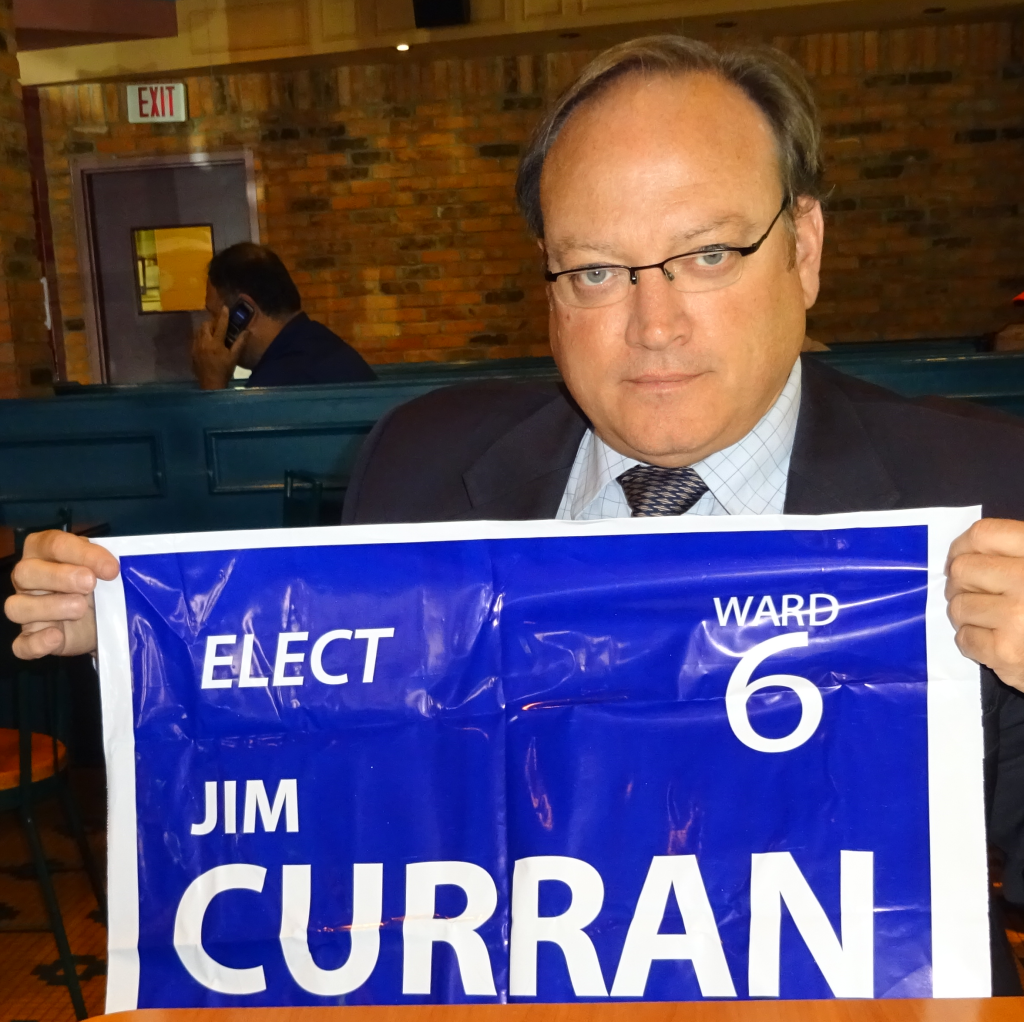 Curran with sign - looking down a bit no person in back