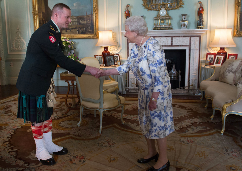 Queen Elizabeth II, in her capacity as Colonel-in-Chief of the Argyll and Sutherland Highlanders of Canada, receives Lieutenant Colonel Lawrence Hatfield (Commanding Officer) at Buckingham Palace in London.