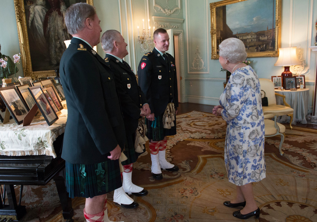 Queen Elizabeth II, in her capacity as Colonel-in-Chief of the Argyll and Sutherland Highlanders of Canada, receives (from left) Colonel Ronald Foxcroft (Honorary Colonel), Lieutenant Richard Kennedy (Honorary Lieutenant Colonel) and Lieutenant Colonel Lawrence Hatfield (Commanding Officer) at Buckingham Palace in London.
