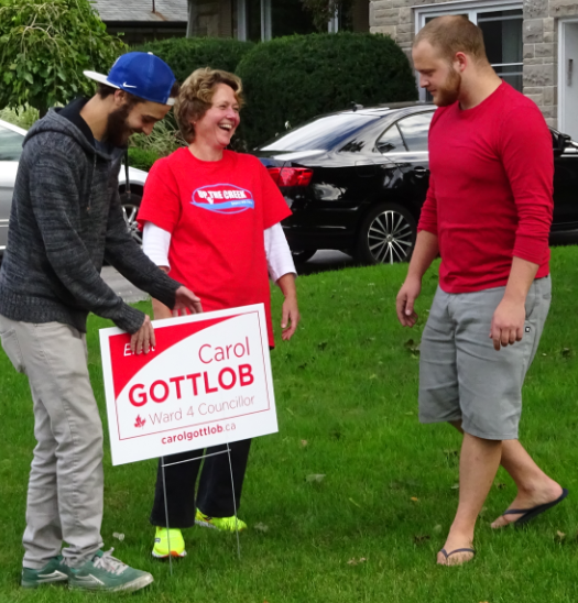 Gottlob signs - front lawn Carol laughing