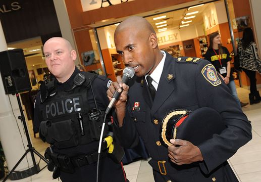 Deputy Chief Nishan Duraiappah pleads his innocence to the charge of Grand Theft Donuts, looking on is Halton Regional Police Detective Constable Paul Proteau.
