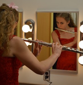 Hayley Remple with flute and red dress