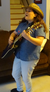 Hayley Verrall - standing with guitar