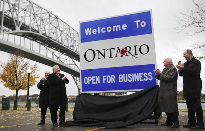 Open for business sign at border