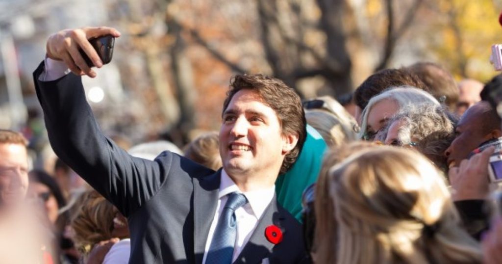 Prime Minister Justin Trudeau takes a selfie as he greets the crowd outside Rideau Hall after being sworn in as Canada's 23rd Prime Minister in Ottawa, Ontario, November 4, 2015. AFP PHOTO/ GEOFF ROBINS (Photo credit should read GEOFF ROBINS/AFP/Getty Images)