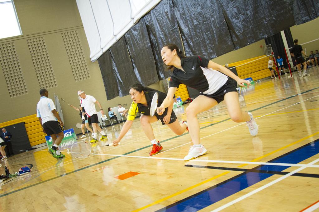 Two woman crouching - badminton