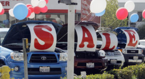 In this Sept. 18, 2010 photo, "Sale" is spelled out in the open hoods of used cars at a Toyota dealership in Glendale, Calif. Retail sales posted a third monthly increase in September as solid gains at auto, furniture and hardware stores helped to offset weakness at clothing and department stores. (AP Photo/Reed Saxon) ORG XMIT: CARS302
