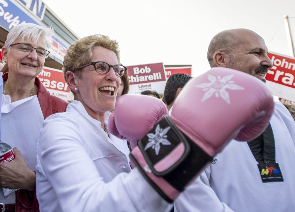 REMOVES REF. TO JOHN FRASER ABSENT FROM PHOTO - Ontario Liberal leader Kathleen Wynne shows off a pair of boxing gloves she received as a gift, while her partner Jane Rounthwaite (left) looks on in Ottawa on Wednesday, May 7, 2014. THE CANADIAN PRESS/Justin Tang