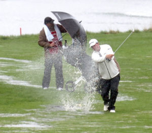 golfers in the rain