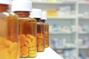Row of bottles and pills on a chemists counter