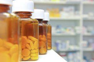 Row of bottles and pills on a chemists counter